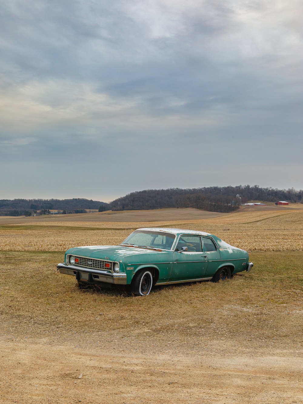 green car on brown field during daytime