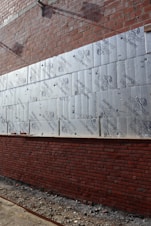 Close-up of a building wall being insulated with thermal panels.