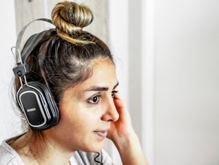 Artist listening intently to high-fidelity sound with headphones on.
