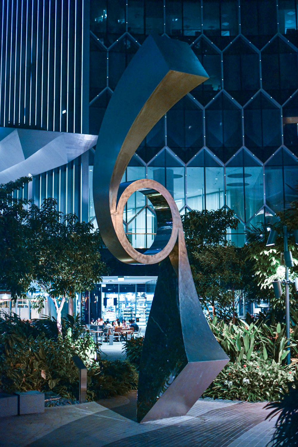 gold round statue near green trees during daytime