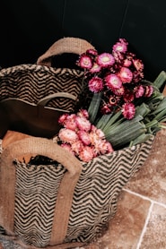 pink and white flower bouquet on brown woven basket