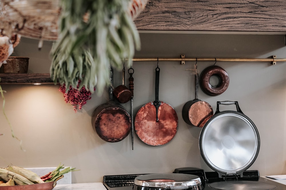 white and red round ceramic plate on black metal rack