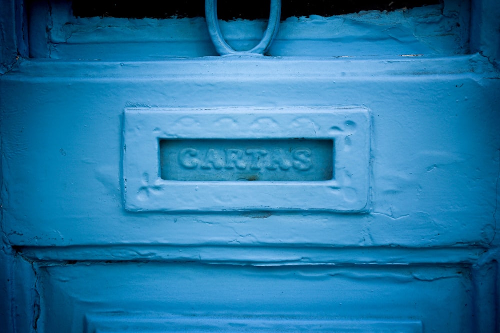 blue wooden door with brown metal padlock