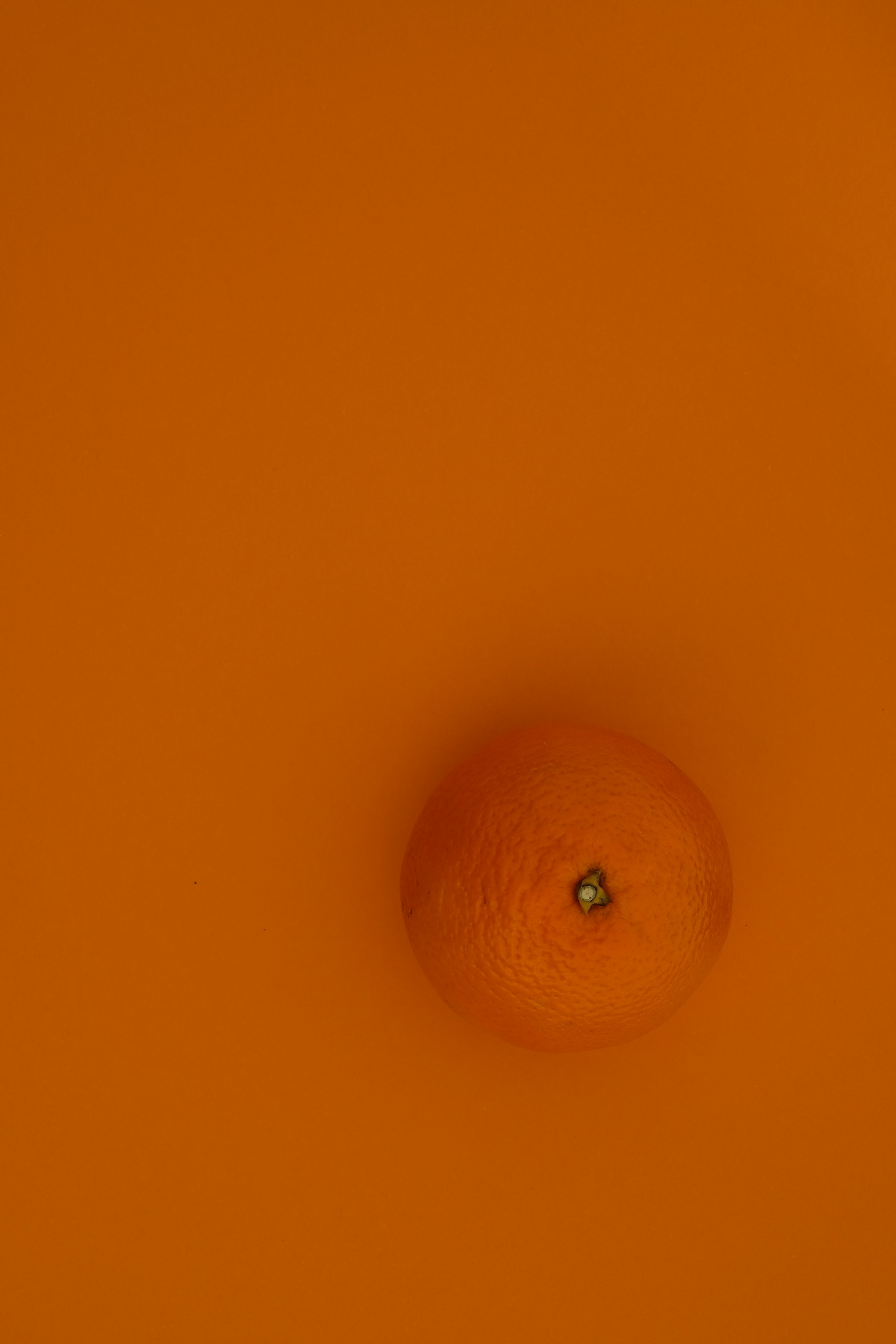 orange fruit on yellow surface