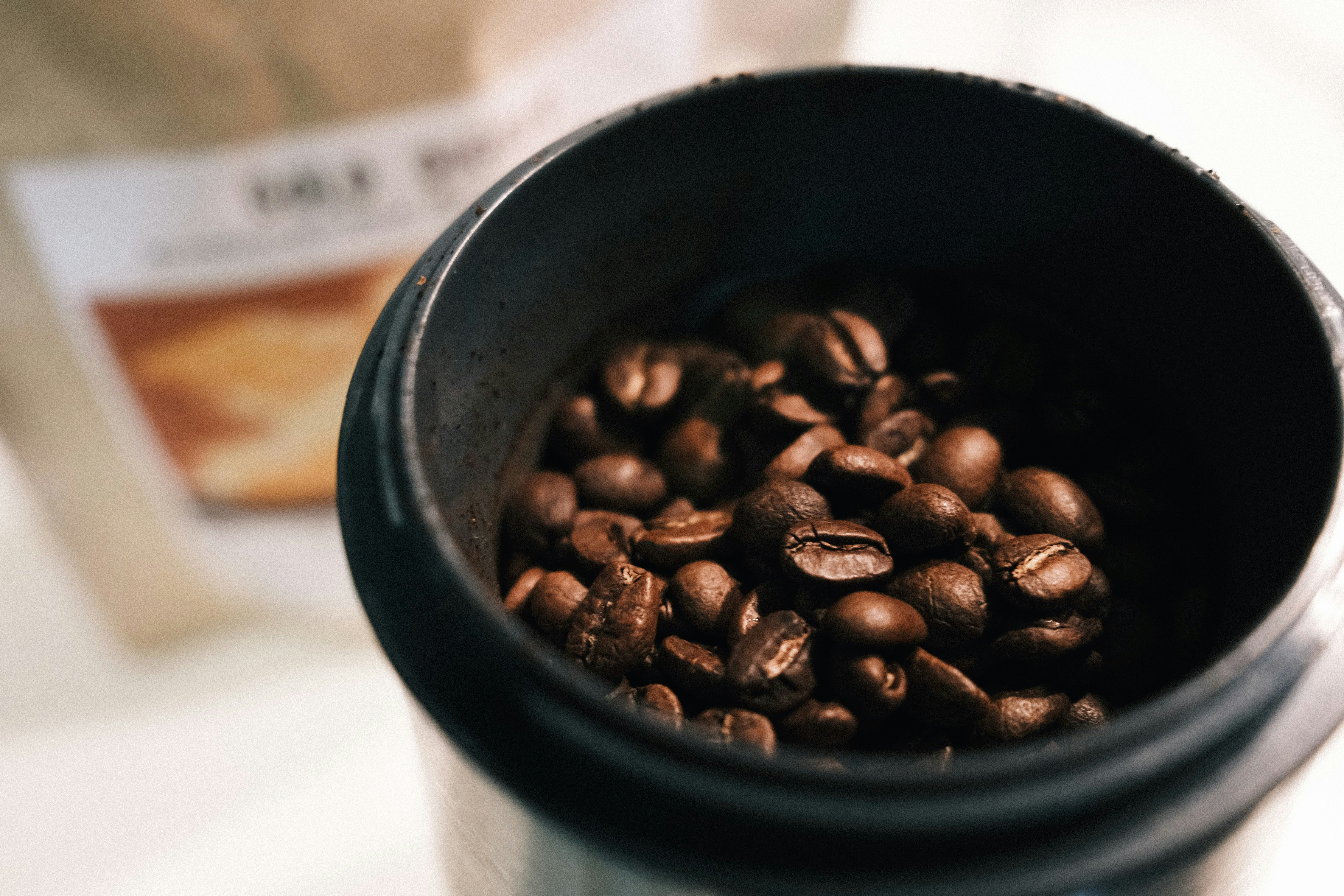coffee beans in black ceramic mug
