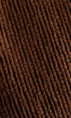 Close-up of a rich corduroy cap in deep burgundy, highlighting its soft texture and meticulous stitching.