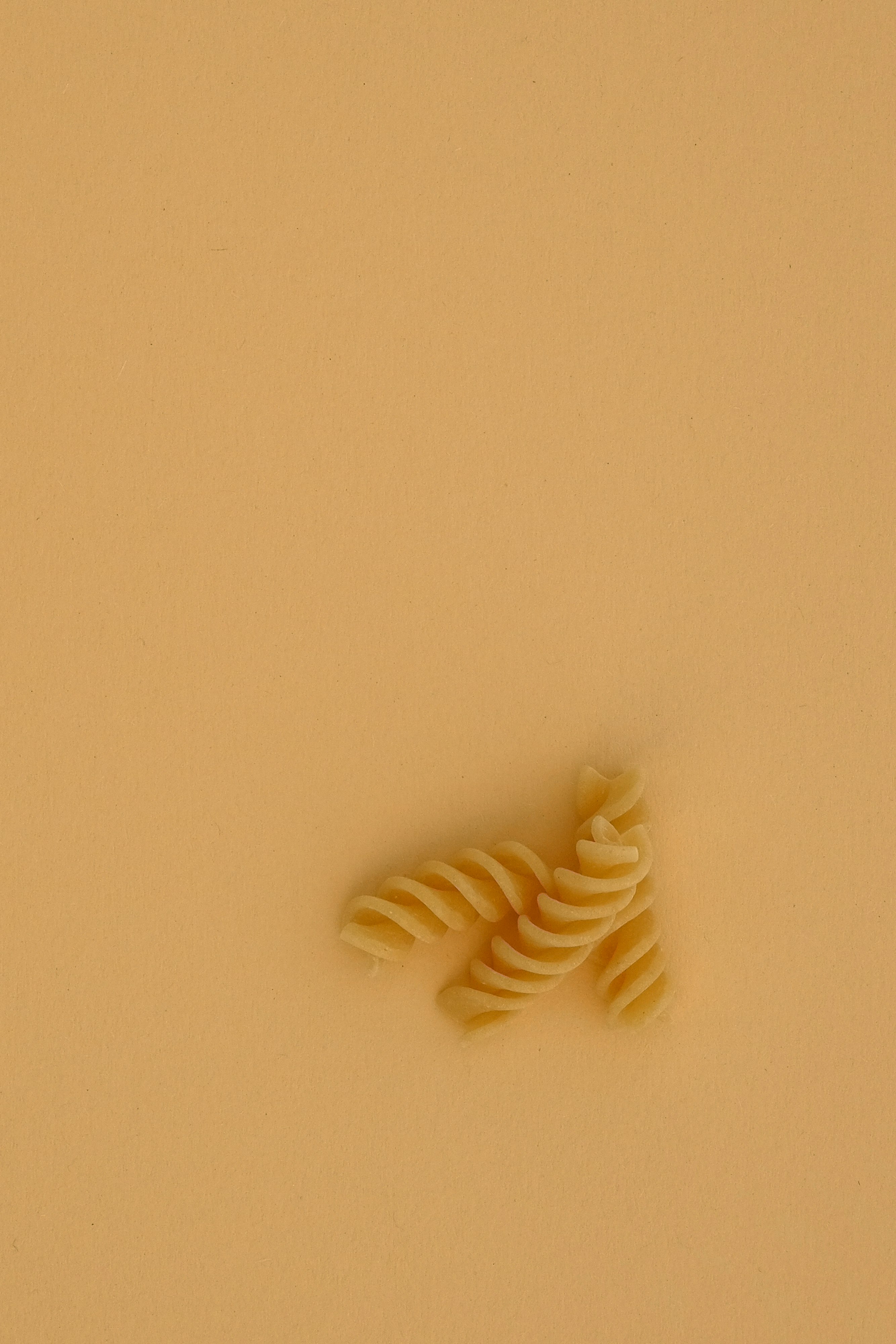 white spiral pasta on white table