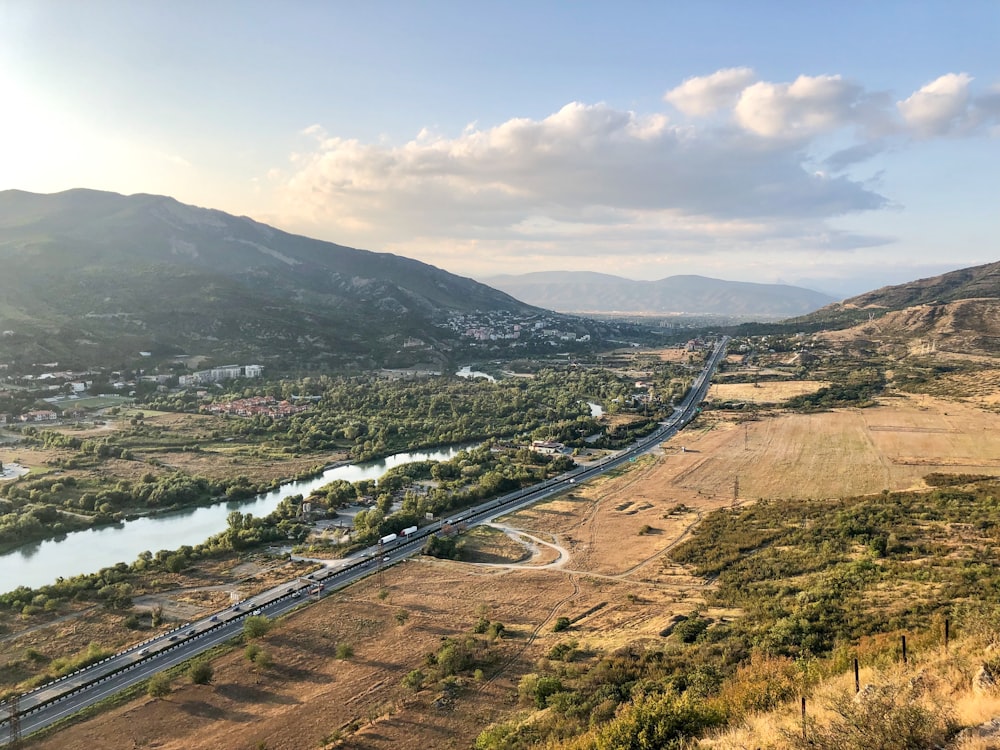 aerial view of road near body of water during daytime