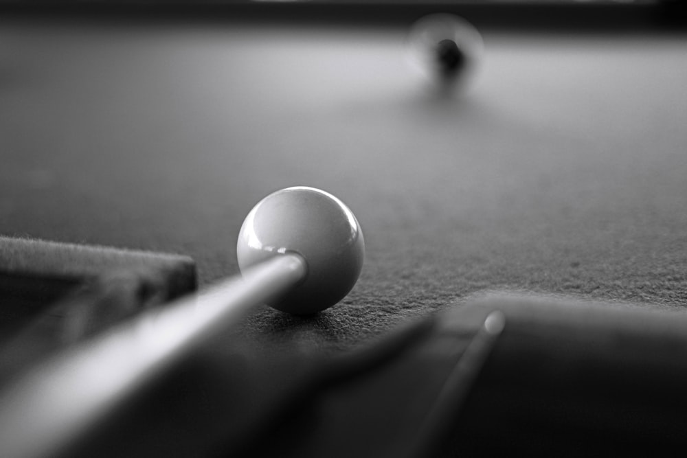 white round ball on black table