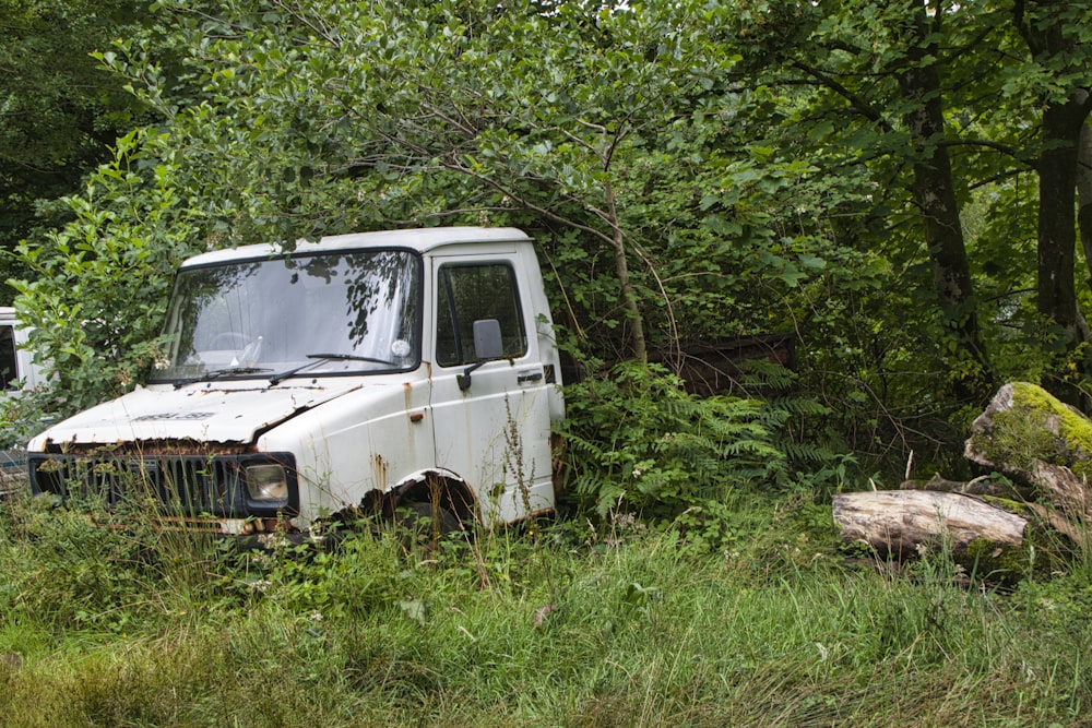 white suv parked on green grass field during daytime