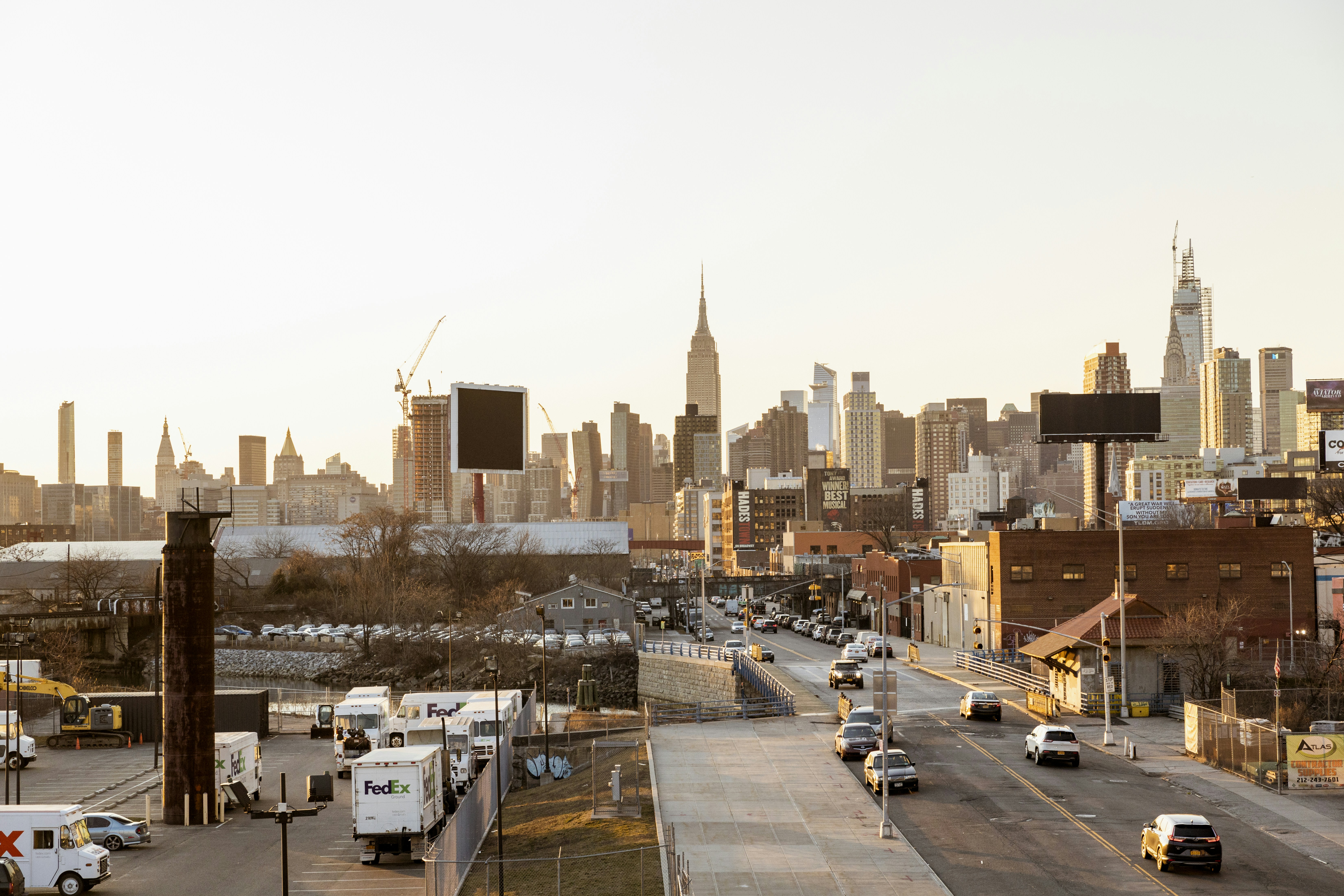 cars on road near city buildings during daytime in Astoria NYC, a great place for foodie roommates to live