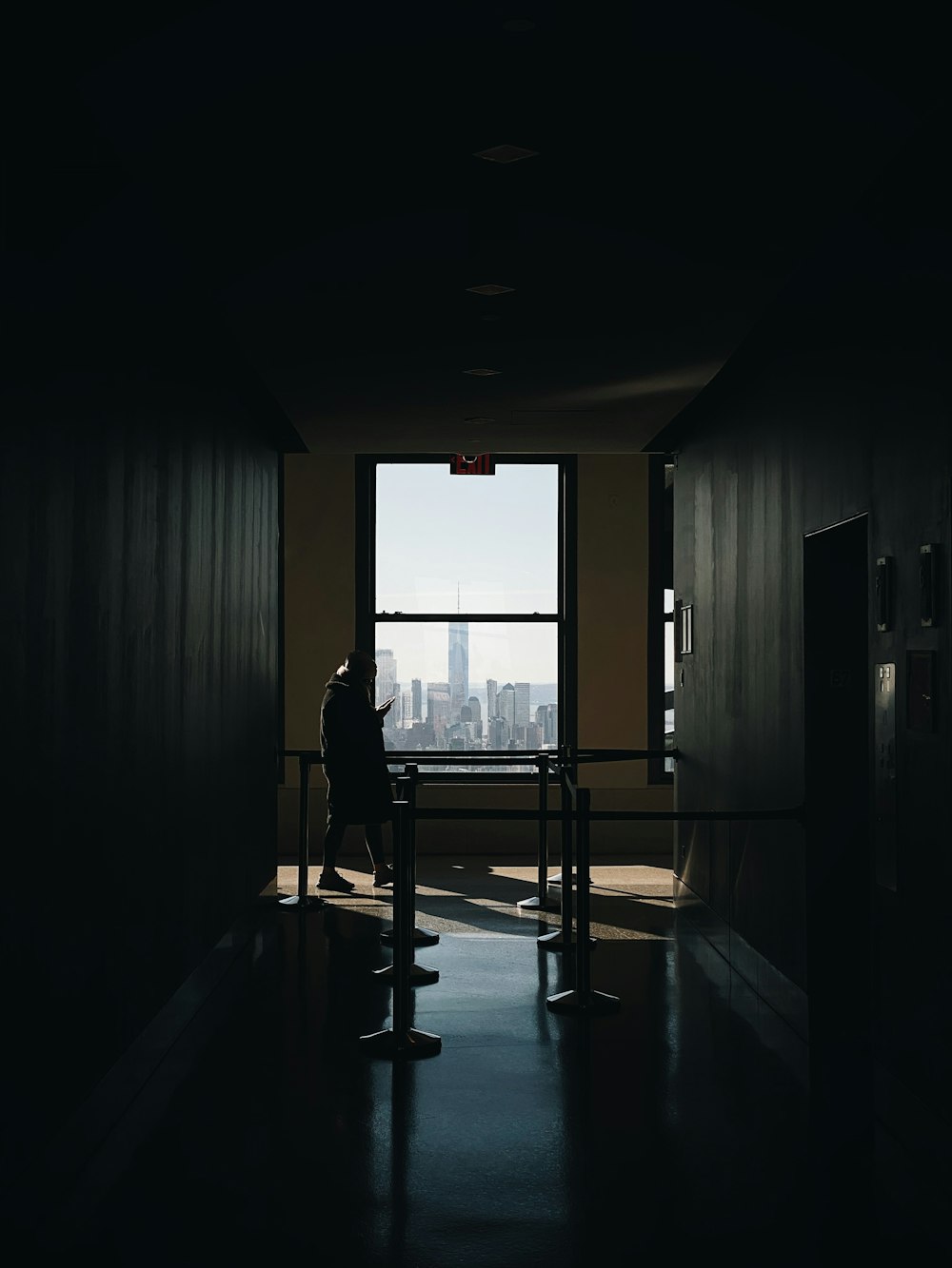 silhouette of people walking on hallway