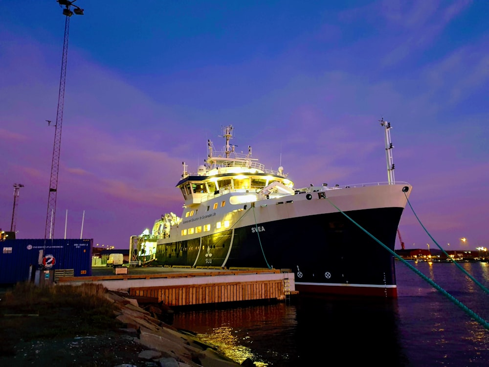 white and blue ship on dock during daytime