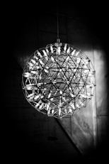 grayscale photo of round glass pendant lamp