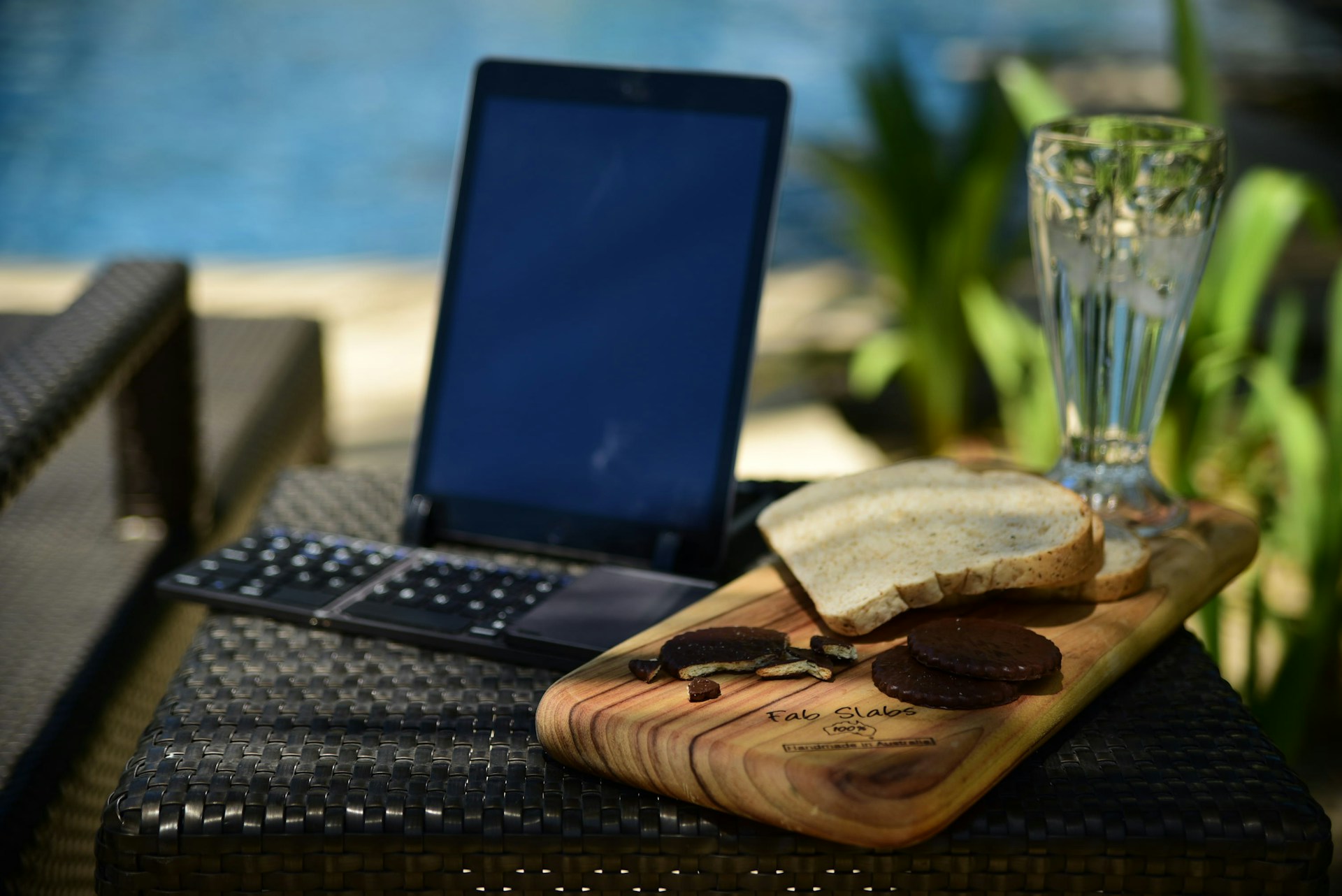 black laptop computer beside brown leather pouch on black table