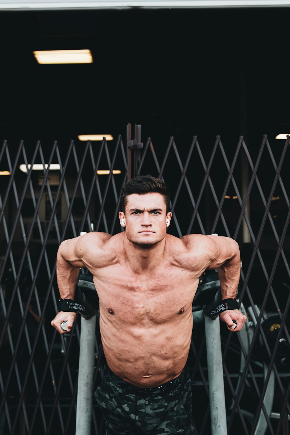 topless man in black shorts wearing black leather gloves