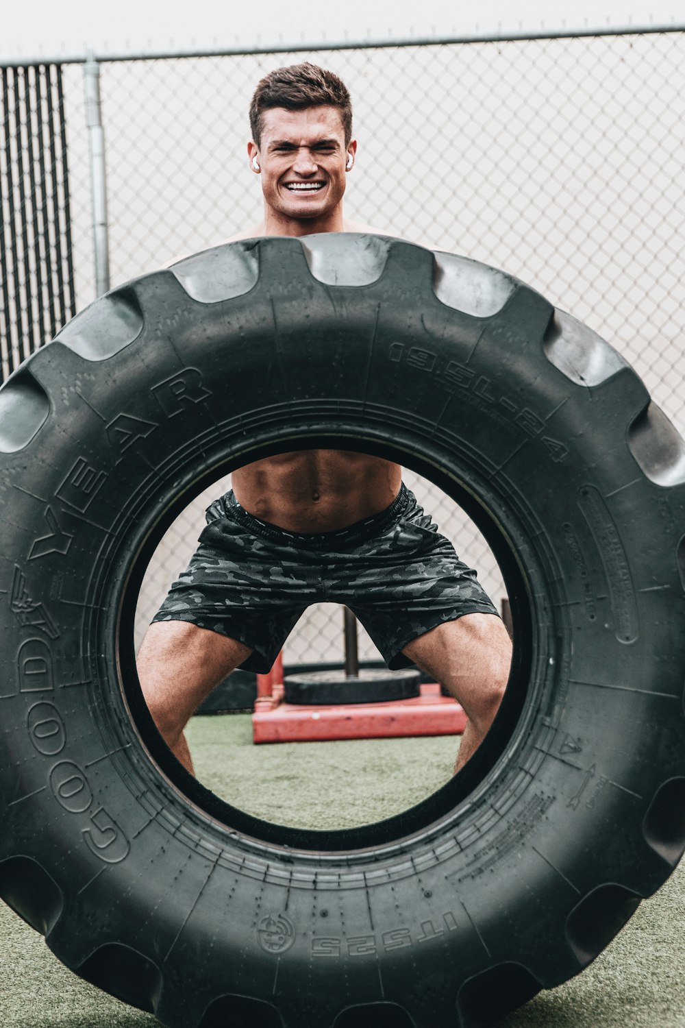 man in black shorts sitting on black tire