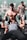 A personal trainer assisting a member with their workout in the gym.