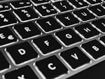 Close-up of a laptop keyboard with rounded keys and a minimalist design.