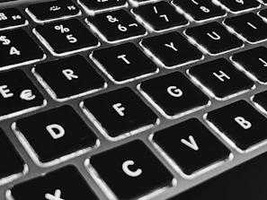 Close-up of a laptop keyboard with rounded keys and a minimalist design.