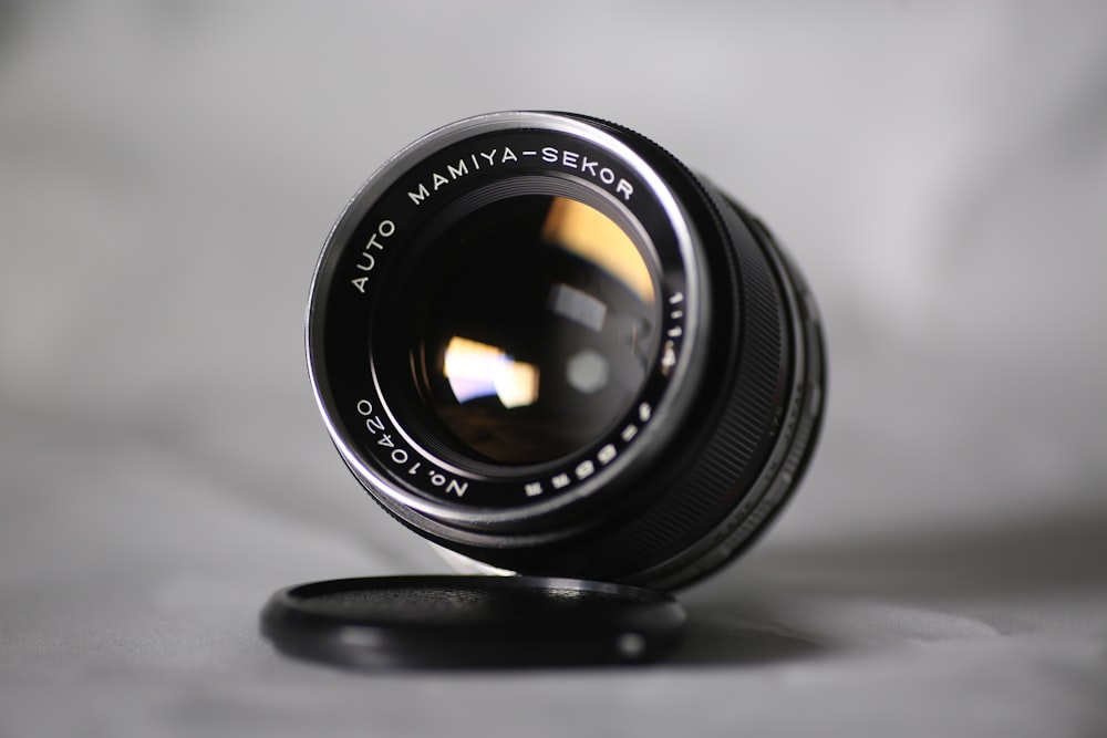 black camera lens on white surface