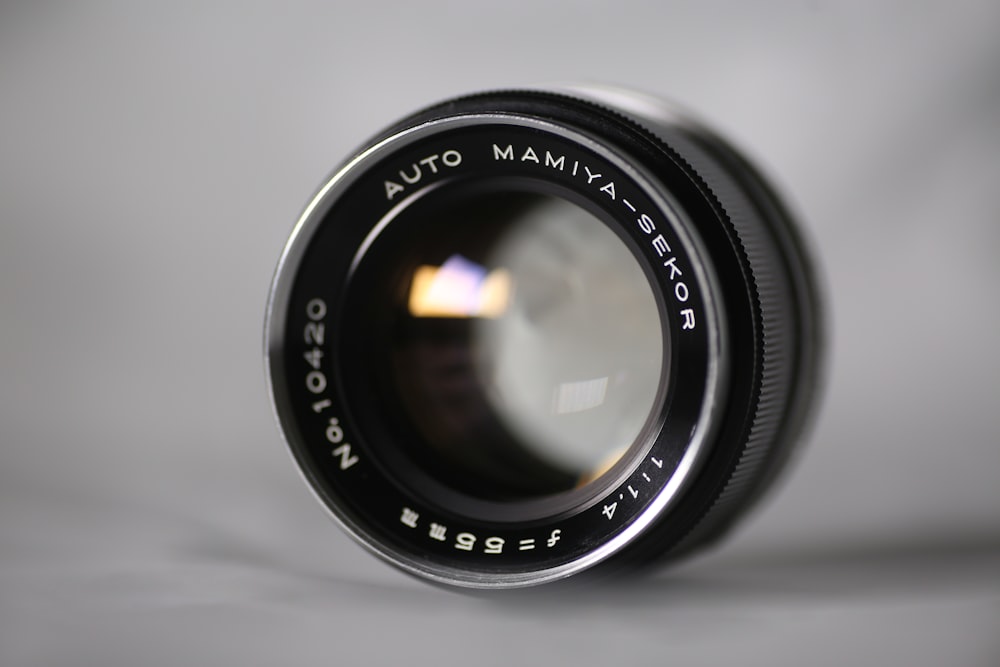 black camera lens on white surface