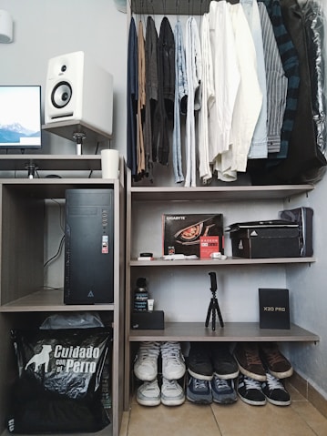 black flat screen tv on brown wooden shelf