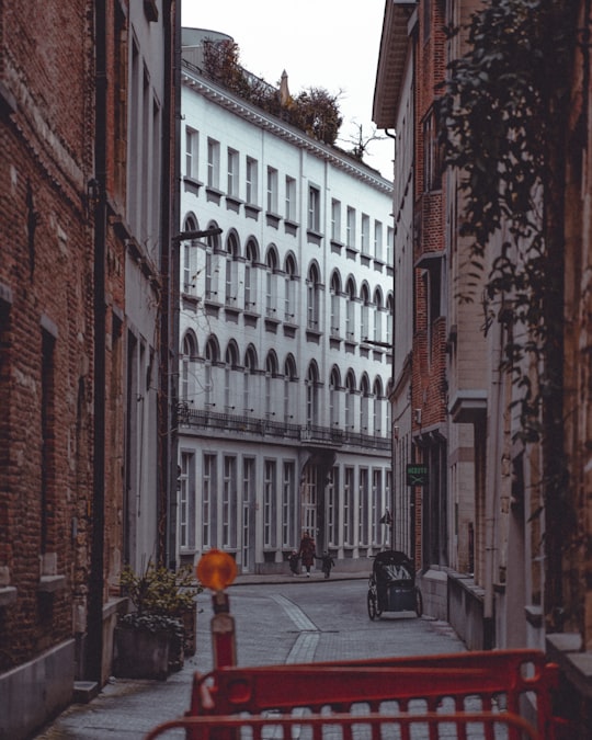 black car parked beside brown concrete building during daytime in Antwerpen Belgium