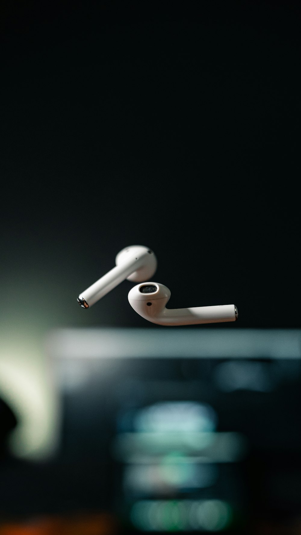 white apple earpods on black background