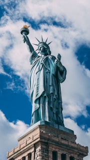 statue of liberty under blue sky during daytime