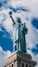 statue of liberty under blue sky during daytime