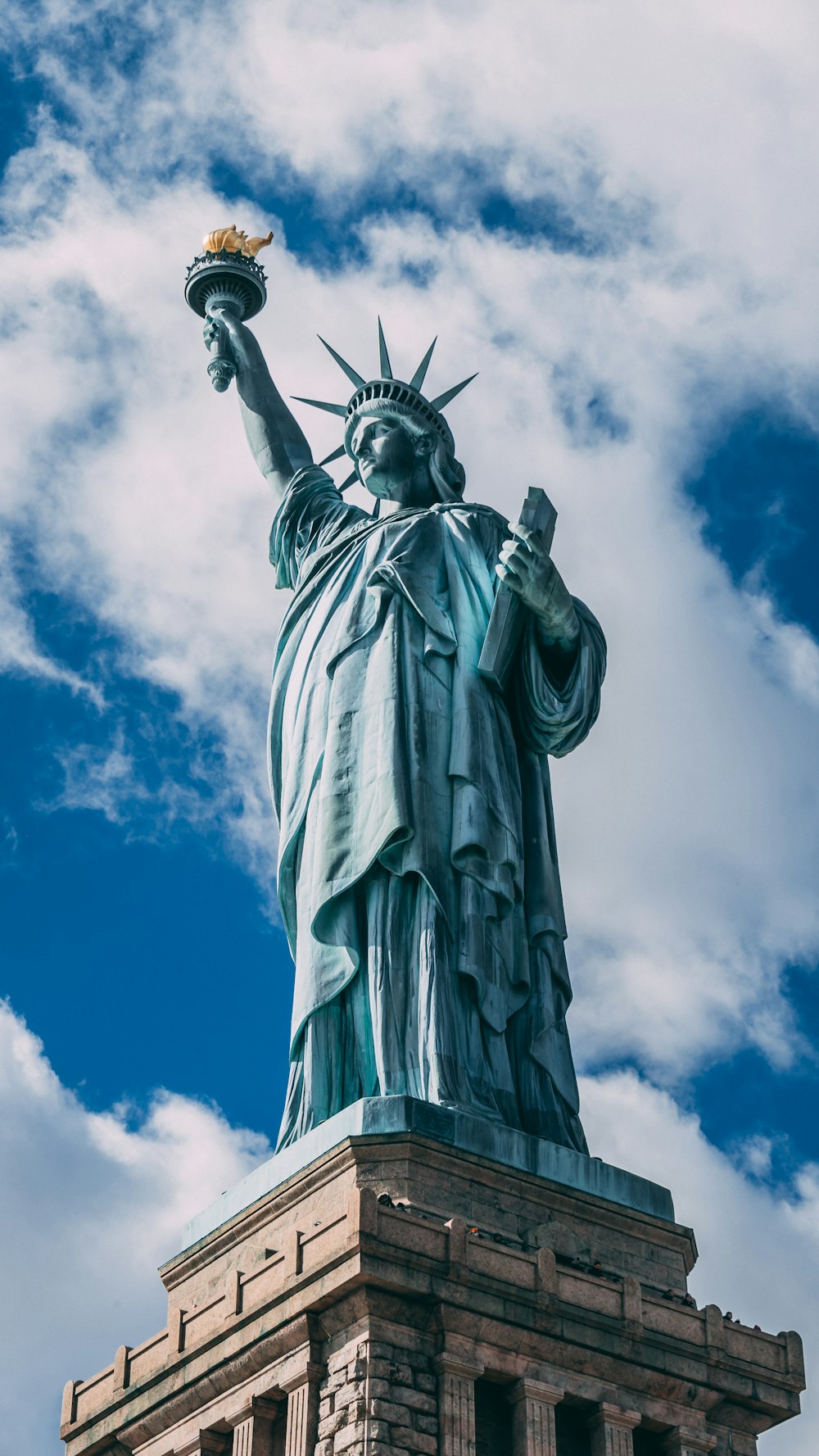 statue of liberty under blue sky during daytime