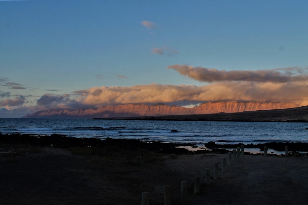 sea waves crashing on shore during sunset