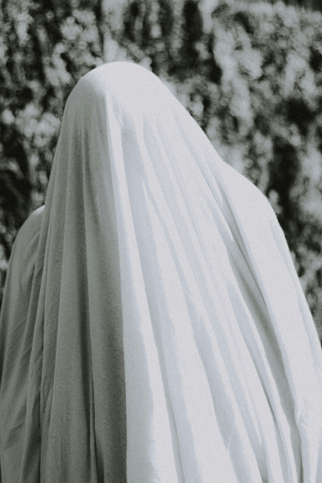 person in white hijab standing near trees