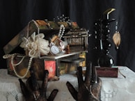 A delicate lace handkerchief displayed beside a vintage jewelry box.