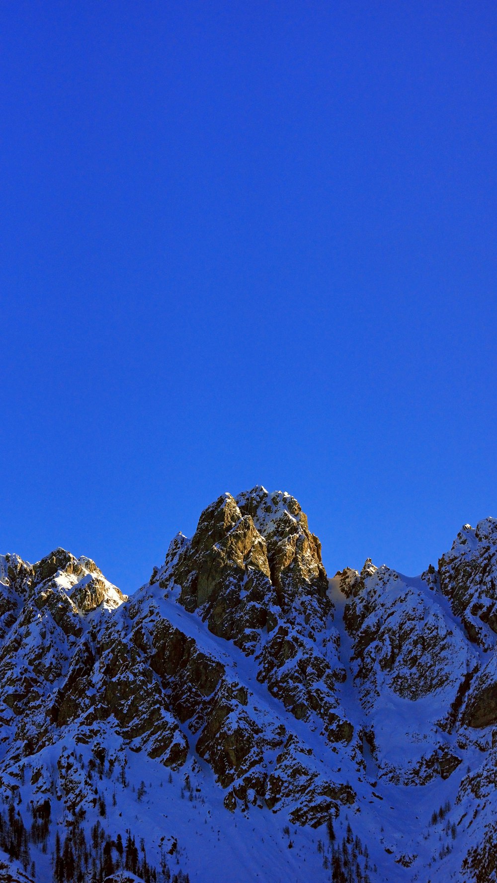 snow covered mountain under blue sky during daytime