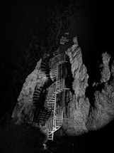 grayscale photo of spiral stairs