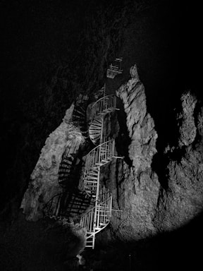 grayscale photo of spiral stairs