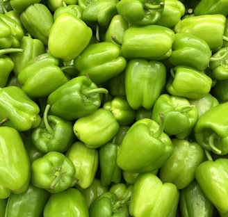 green bell pepper on brown wooden table