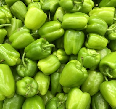 green bell pepper on brown wooden table