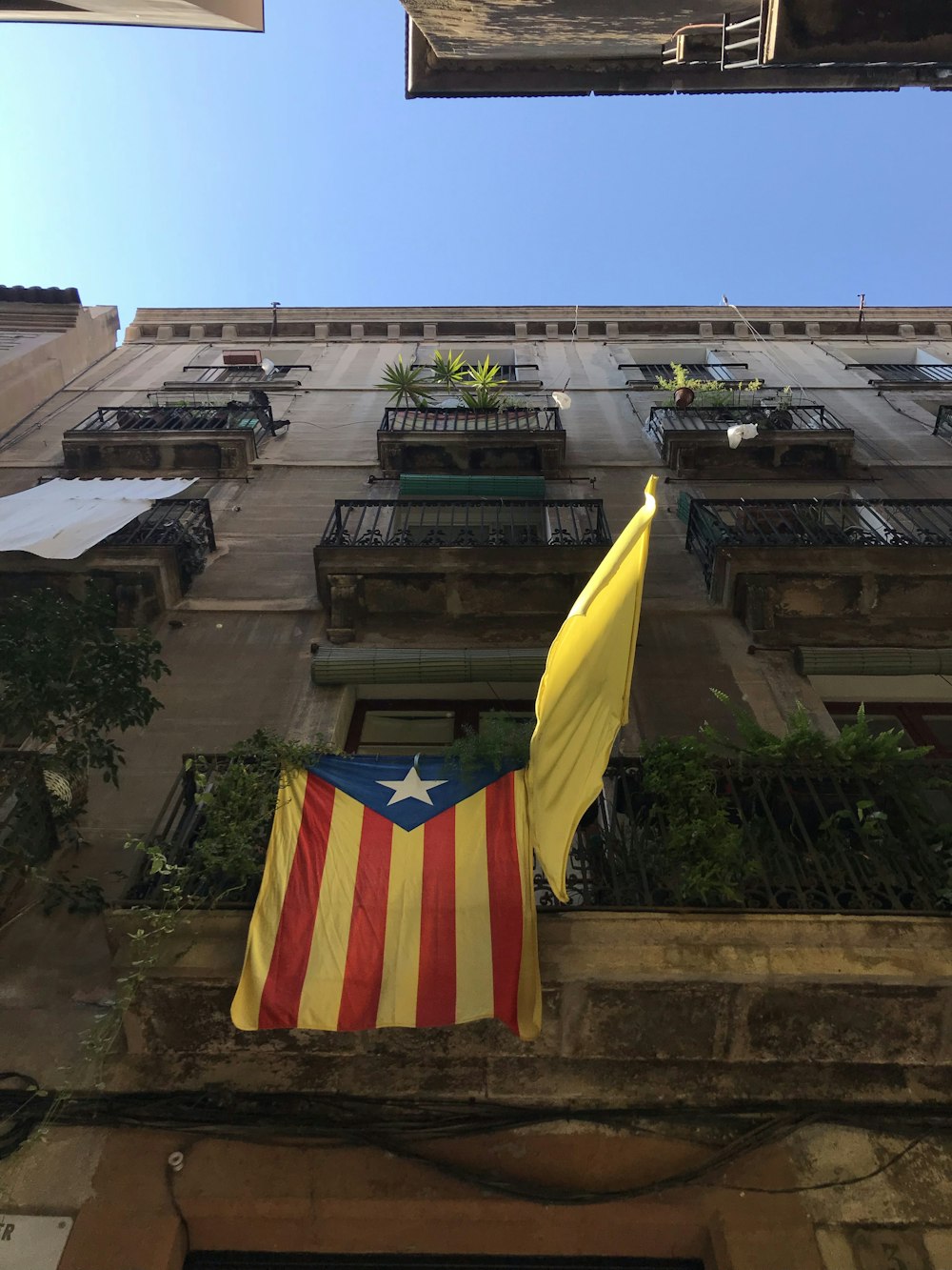 yellow and red striped flag on top of building