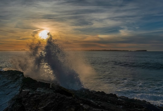 ocean waves crashing on shore during sunset in Baleal Portugal