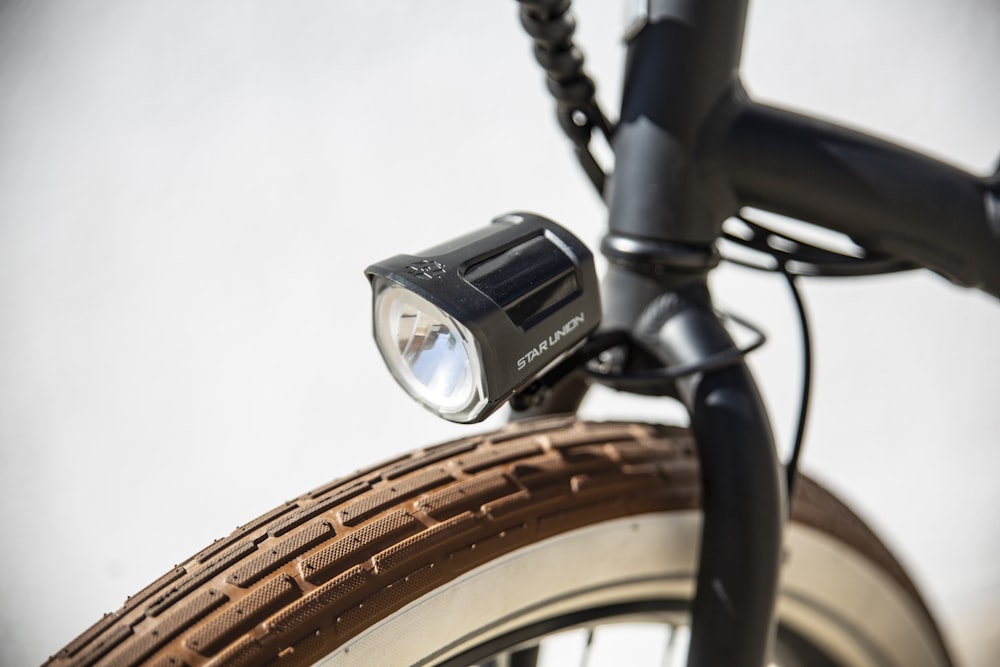 black and silver camera on black bicycle handle bar