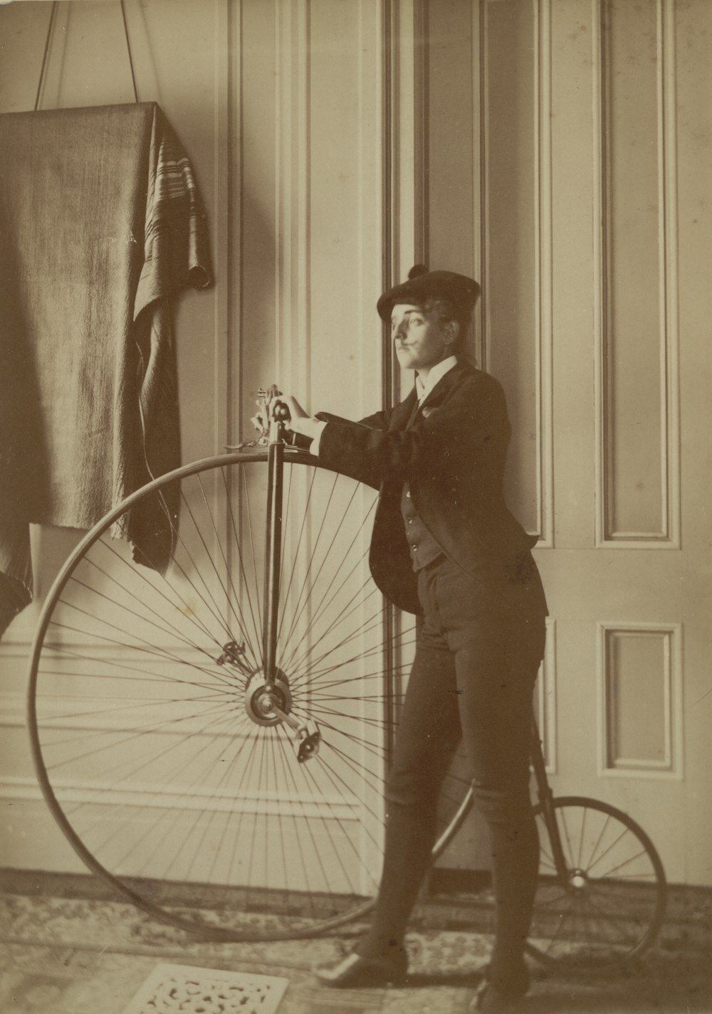 Frances Benjamin Johnston, posed with bicycle