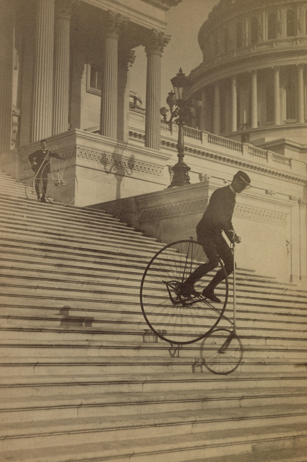 Man riding a bicycle down the steps of the U.S. Capitol