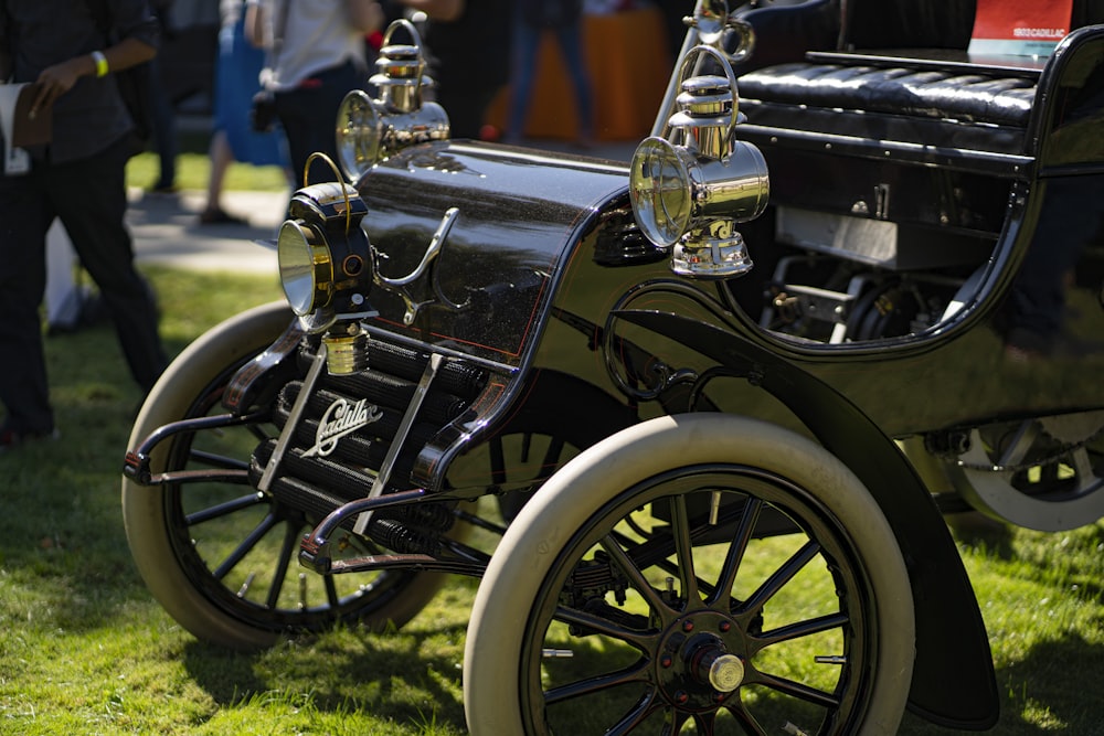 black vintage car on green grass field during daytime