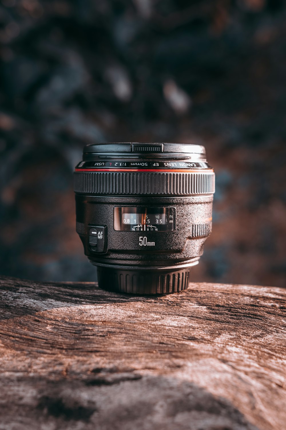 black camera lens on brown wooden table