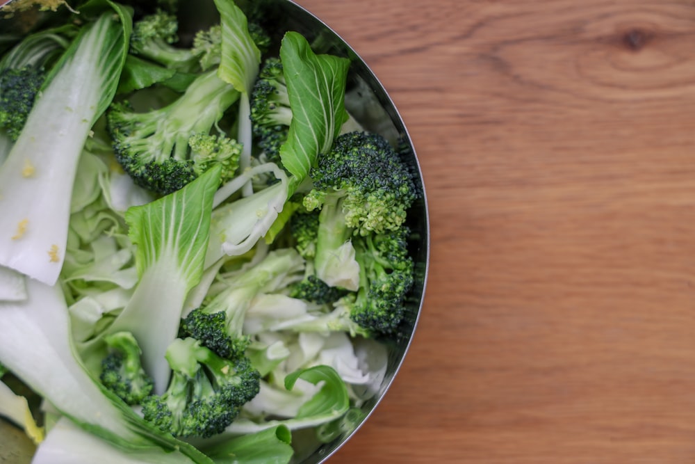 green vegetable on brown wooden table