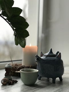 A cozy cottagecore scene with anthropomorphic animals enjoying tea under a canopy of blooming branches.