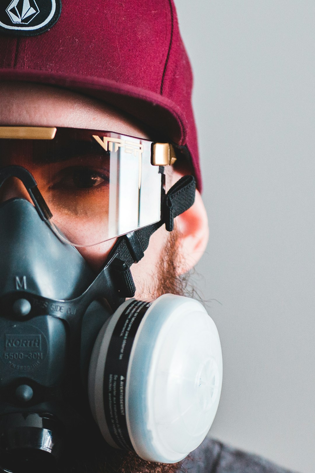 man in pink and black gas mask